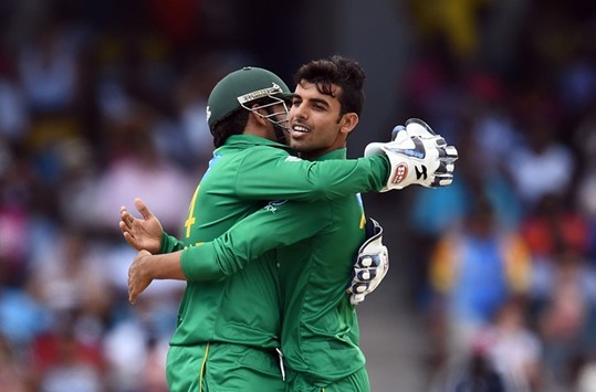 Pakistanu2019s Shadab Khan (R) celebrates with captain Sarfraz Khan after dismissing West Indiesu2019 Sunil Narine during the first T20 match in Bridgetown, Barbados. (AFP)
