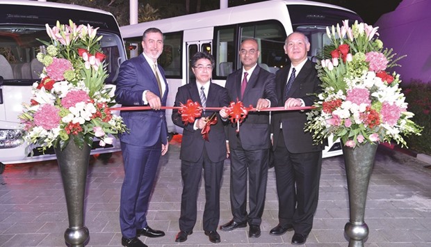 The redesigned Toyota Coaster being launched in Qatar by Toyota and AAB officials.