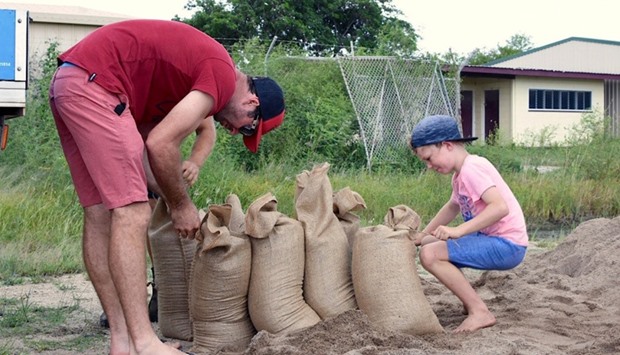 Residents fill sandbags in preparation for the arrival of Cyclone Debbie in the northern Australian town of Bowen, located south of Townsville
