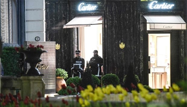 Monaco's police officers stand guard in front of the Cartier jewellery boutique after it was robbed in Monaco on Saturday.