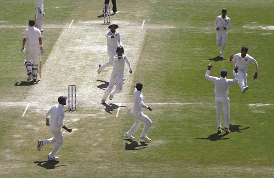Indiau2019s Umesh Yadav (right) celebrates with his teammates after dismissing Australiau2019s Matt Renshaw during the fourth Test in Dharamsala, India, yesterday. (Reuters)