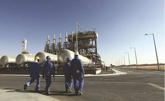 Workers walk inside the Shams 1, Concentrated Solar power (CSP) plant, in Al-Gharibiyah district on the outskirts of Abu Dhabi (file). The Gulf country plans to invest $150bn in renewable power to 2050, weening the country from dependency on subsidised natural gas power in stages, Minister of Energy Suhail al-Mazrouei said at a conference in Berlin. Clean energy sources will help it save $192bn, he said.