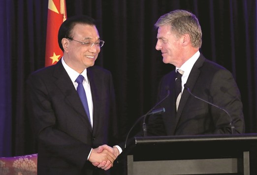 Chinese Premier Li Keqiang (left) shakes hands with New Zealandu2019s Prime Minister Bill English during a media conference in Wellington yesterday. Li signed nine trade pacts with English.