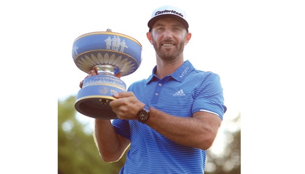 Dustin Johnson of the USA poses with the trophy after winning the World Golf Championships in Austin, Texas.