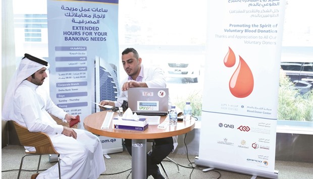 A Doha Bank staffer being examined before blood donation.
