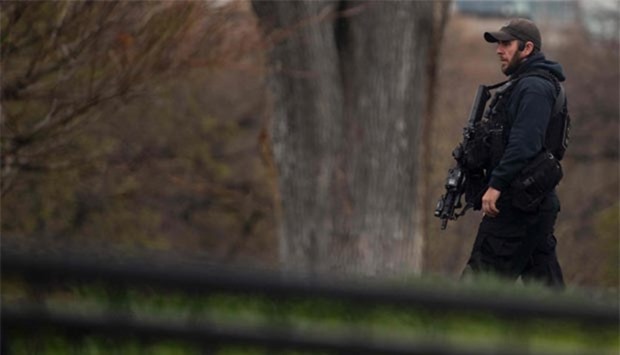 A Secret Service officer patrols the north lawn at the White House in Washington, DC, on Tuesday.