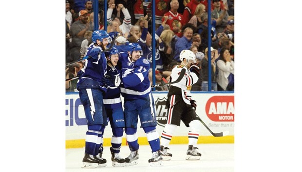 Tampa Bay Lightning centre Yanni Gourde (centre) celebrates with defenseman Victor Hedman (L) and left wing Alex Killorn after Gourde beat Chicago Blackhawks goalie Scott Darling to score the game-winning overtime goal in Tampa, Florida. (Tampa Bay Times)