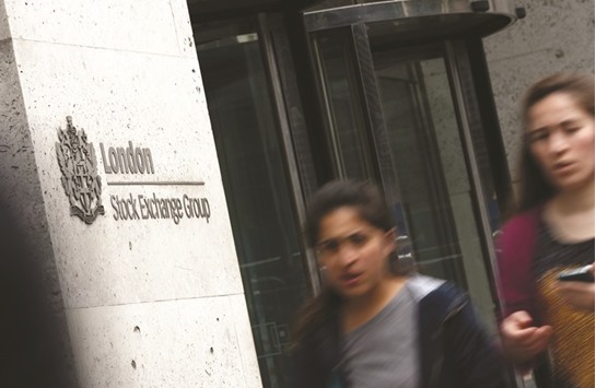 Pedestrians walk past the London Stock Exchange. The FTSE 100 rose 0.7% to 7,343.42 points yesterday.
