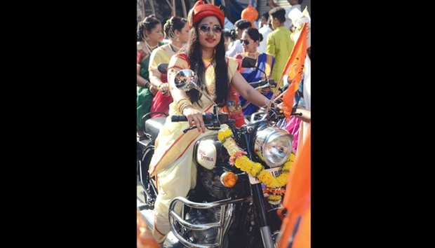 Women dressed in traditional costumes ride motorbikes as they attend celebrations to mark the Gudi Padwa festival, the beginning of the New Year for Maharashtrians, in Mumbai, yesterday.
