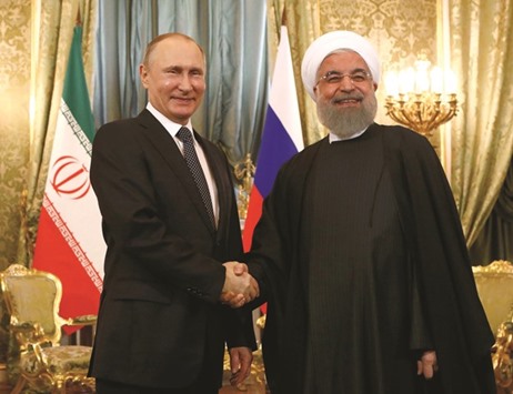 Russian President Vladimir Putin shakes hands with Iranian President Hassan Rouhani during their meeting at the Kremlin in Moscow yesterday.
