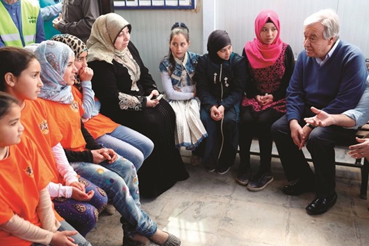 United Nations Secretary General Antonio Guterres (right) talks to Syrian women and girls during a visit to the Zaatari refugee camp, Jordan, which shelters some 80,000 Syrian refugees on the border yesterday.