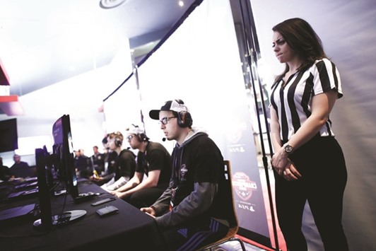 A referee watches competitors play Call of Duty: Infinite Warfare on the Playstation 4, during the Cineplex WorldGaming Canadian Championship Series, an esports video game tournament for C$65,000 total prize money, in Toronto, Canada.