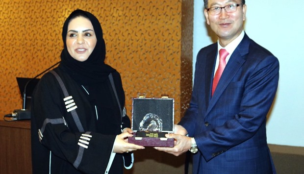 South Korean ambassador Heung Kyeong Park receiving a memento from HBKU associate vice president of student affairs Sheikha Hanan al-Thani at the opening of the festival on Sunday.