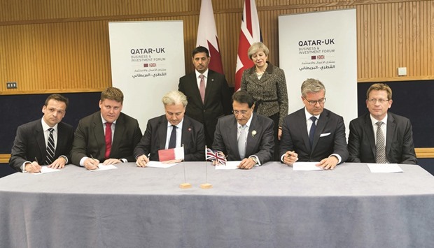 HE the Prime Minister and Minister of Interior Sheikh Abdullah bin Nasser bin Khalifa al-Thani and UK Prime Minister Theresa May witness the signing of a shareholders agreement for Qatar Investment Authorityu2019s (QIA) acquisition of a share in National Grid, the UKu2019s gas distribution company, yesterday.