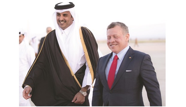 HH the Emir Sheikh Tamim bin Hamad al-Thani being received by King Abdullah II at the Queen Alia International Airport yesterday.