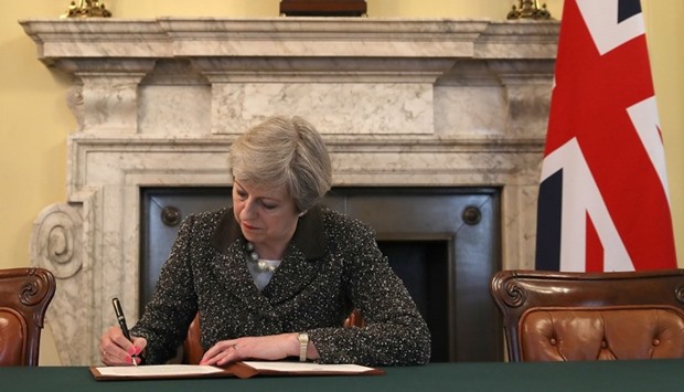 Britain's Prime Minister Theresa May, signs the official letter to European Council President Donald