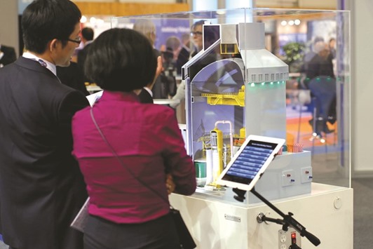 Visitors look at a nuclear power plant model by Toshibau2019s US unit Westinghouse at the World Nuclear Exhibition in Le Bourget, near Paris. The Japanese firm said Westinghouse-related liabilities totalled $9.8bn as of December, making it one of the industryu2019s most costly collapses to date.
