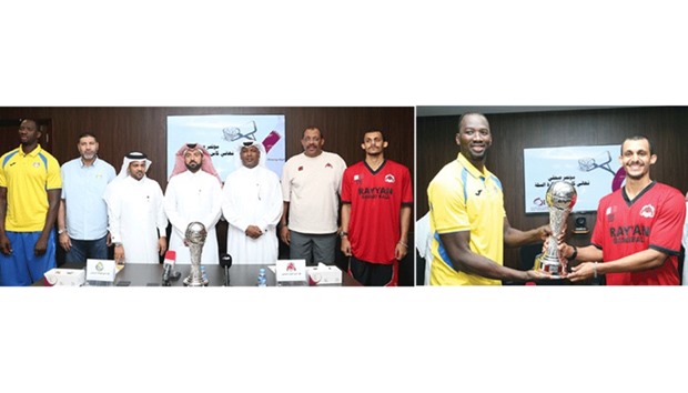 Al Gharafa and Al Rayyan players and coaches pose with Qatar Basketball Federation Secretary General Ali al-Malki (fourth from left) and other officials at the press conference. At right, Al Gharafau2019s Omar Abdelkader Salem and Al Rayyanu2019s Mohamed Hassan Mohamed pose with the Qatar Cup trophy. Pictures: Jayan Orma
