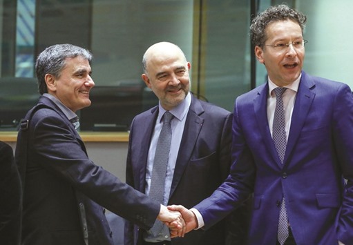 Greek Finance Minister Euclid Tsakalotos (left), European Economic and Financial Affairs Commissioner Pierre Moscovici (centre) and Dutch Finance Minister and Eurogroup President Jeroen Dijsselbloem take part in a eurozone finance ministers meeting in Brussels. Greece hopes that wrapping up the second review of bailout progress will pave the way for crucial talks on post-bailout debt relief.