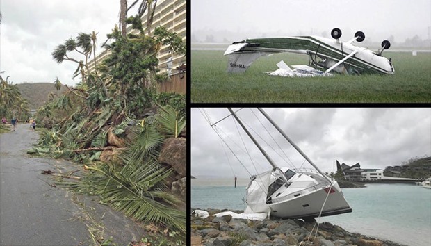 LEFT: Fallen trees on Hamilton Island after strong Cyclone Debbie hit the Whitsundays Islands in Queensland.  TOP RIGHT: A plane that was flipped by strong winds from Cyclone Debbie is seen at the airport in the town of Bowen, located south of the northern Australian city of Townsville.  BELOW RIGHT: A yacht washed up at the marina on Hamilton Island.