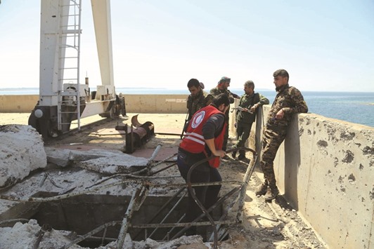Syrian Arab Red Crescent members and Syrian Democratic Forces (SDF) inspect yesterday the Tabqa dam which has been recently partially recaptured by US-backed SDF as part of their battle for the Islamic State groupu2019s stronghold in nearby Raqqa.