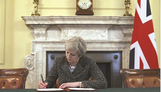 Britainu2019s Prime Minister Theresa May signs the official letter to European Council President Donald Tusk, invoking Article 50 and signalling the United Kingdomu2019s intention to leave the EU, in the cabinet office inside 10 Downing Street on Tuesday.