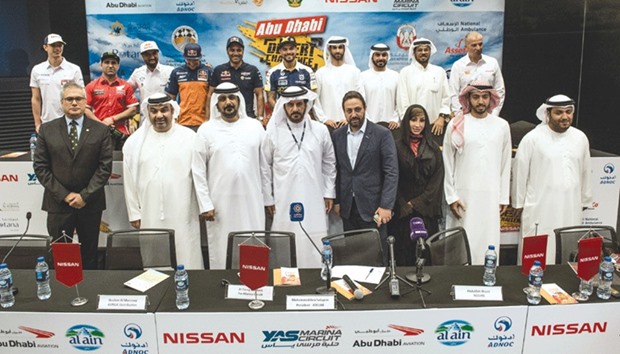 Drivers and officials pose during a pre-event press conference for the Abu Dhabi Desert Challenge.