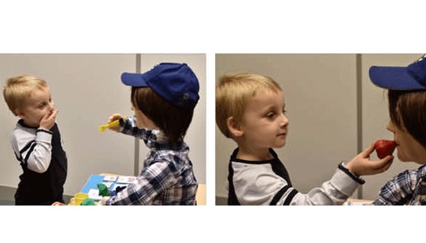 Harrison, 5, who is autistic, plays with Kaspar, a child-sized humanoid robot developed at the University of Hertfordshire to interact and help improve the lives of children with autism, in Stevenage, Britain.
