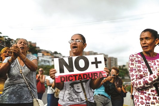 Activists march along a street of Caracas yesterday, chanting slogans against the Maduro government.