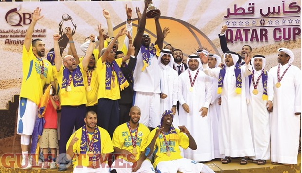 Al Gharafa players celebrate their success with basketball officials after their Qatar Cup victory yesterday. Picture: Jayan Orma