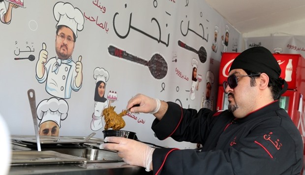 Qatari chef, Jassim Mohamed al-Kharraz, of u2018We Cafu00e9u2019 prepares a Qatari dish.