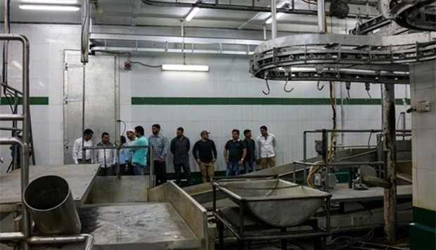 Indian workers stand inside an empty abattoir in Meerut last week.