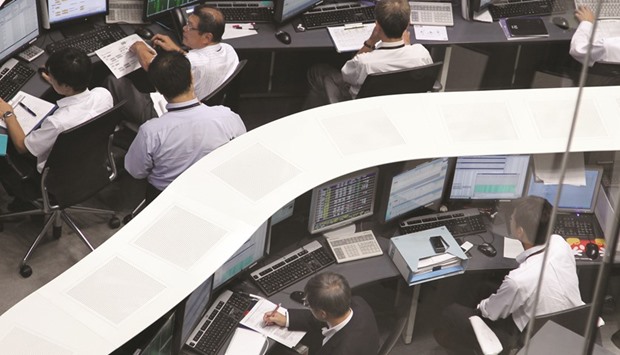 Traders work at the Tokyo Stock Exchange. The Nikkei 225 closed down 0.5% to 19,469.17 points yesterday.