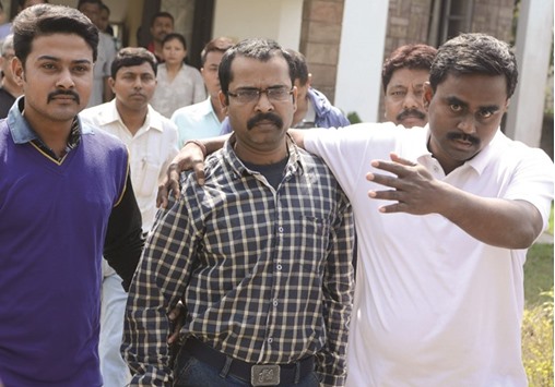 Crime Investigation Department (CID) officials escort Child Welfare Officer (CWC) Debashis Chandra (centre) from CID office in Siliguri yesterday for an appearance at a court in Jalpaiguri.