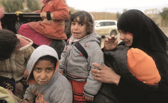 A displaced Iraqi woman and her daughter cry while fleeing their homes, as Iraqi forces battle with Islamic State militants in western Mosul yesterday.