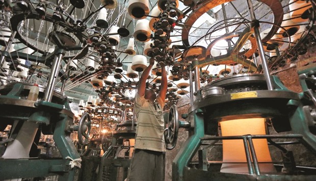 An employee works inside a garment factory in Kolkata. India is expected to grow at 7.1% in the year through March, the slowest pace since 2014 but still among the fastest in the world, and easily beating the 6.8% median estimate in a Bloomberg survey of 30 economists.