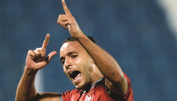 Prolific Lekhwiya forward Yousef El Arabi celebrates in his trademark style after scoring against Al Kharaitiyat yesterday.