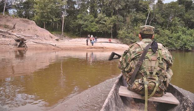 A soldier travels up the Segua river by boat to cocoa farms near Guerima village in the municipality of Cumaribo, Vichada department, eastern Colombia.