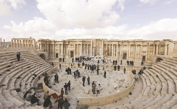 Journalists at the site of the damaged Roman amphitheatre in the ancient city of Palmyra in central Syria yesterday, as part of a tour organised by the Syrian army. Syrian troops backed by Russian jets completed the recapture of the historic city of Palmyra from Islamic State (IS) group fighters on March 2, 2017, the Kremlin and the army said.