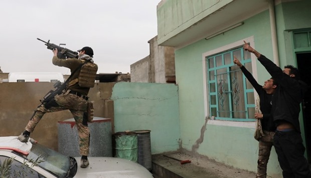 An Iraqi special forces soldier fires at a drone operated by Islamic State militants Islamic State militants in Mosul.