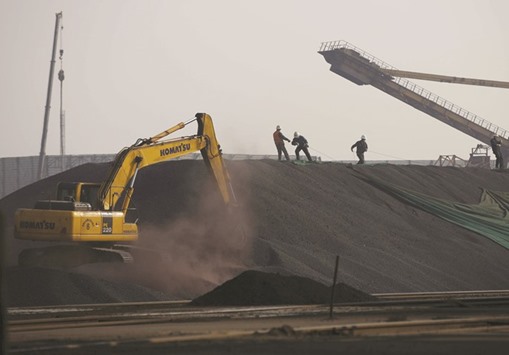 Labourers work on a pile of iron ore at a steel factory in Tangshan, China. Iron ore, already on its best run of monthly gains in almost five years, could beat expectations in 2017 and touch the $100 a tonne level for the first time since mid-2014 as government support propels Chinau2019s surging steel appetite.