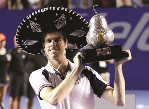 USAu2019s Sam Querrey holds up the trophy after winning his final match against Spainu2019s Rafael Nadal. (Reuters)