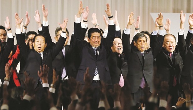 Japanu2019s Prime Minister and the ruling Liberal Democratic Party President Shinzo Abe (centre) and his party members take Banzai cheers at the end of their annual convention in Tokyo yesterday.