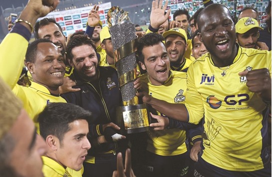 Peshawar Zalmi players, led by Darren Sammy, (R), celebrate their victory over Quetta Gladiators in the final of the Pakistan Super League (PSL) in Lahore yesterday.