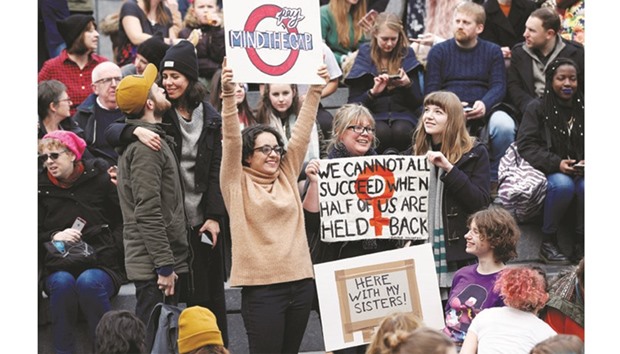 Participants wave placards ahead of the u2018March4Womenu2019 demonstration, in London yesterday.