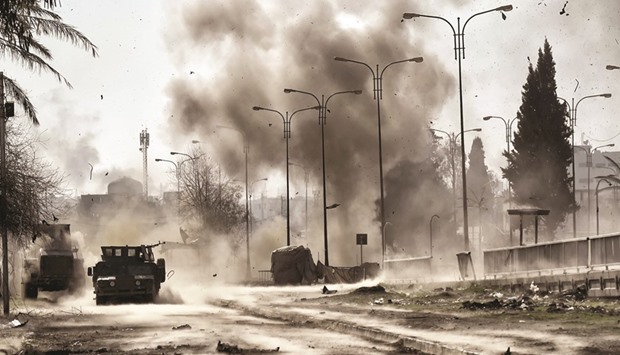 Smoke billows following a car bomb explosion as Iraqi forces clash with Islamic State (IS) group fighters in Mosul yesterday.
