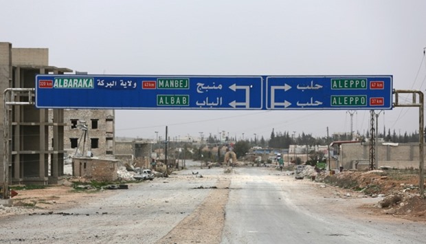A road sign that shows the direction to Manbij city is seen in the northern Syrian town of al-Bab, Syria