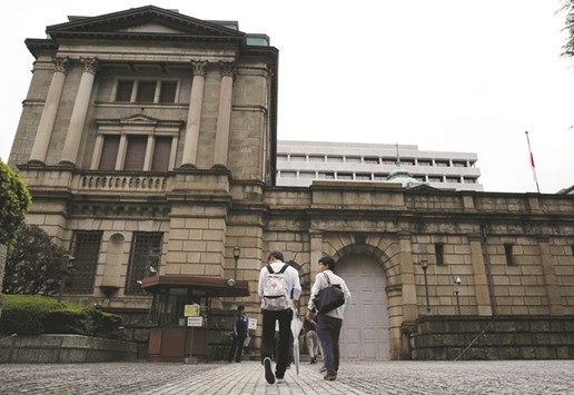 Men walk towards the Bank of Japan building in Tokyo. The Japanese central banku2019s policy of capping borrowing costs has come under increasing pressure as stronger US economic growth and signs of inflation globally have pushed up bond yields around the world.