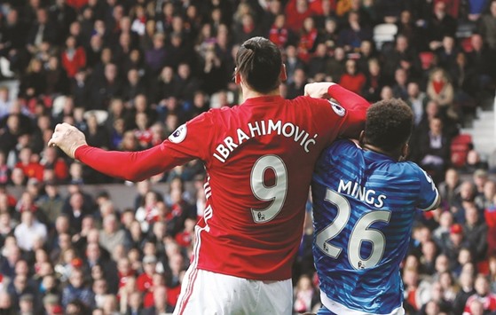 File picture of Bournemouthu2019s Tyrone Mings being challenged by Manchester Unitedu2019s Zlatan Ibrahimovic.