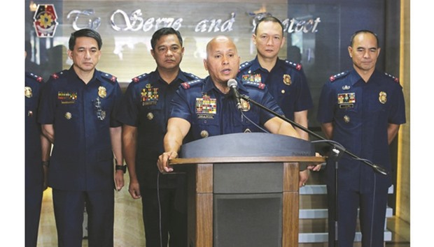 This handout photo released by the Philippine National Police-Public Information Office (PNP-PIO) yesterday shows national police chief Ronald Dela Rosa (centre) speaking during a press conference at the national police headquarters in Manila.